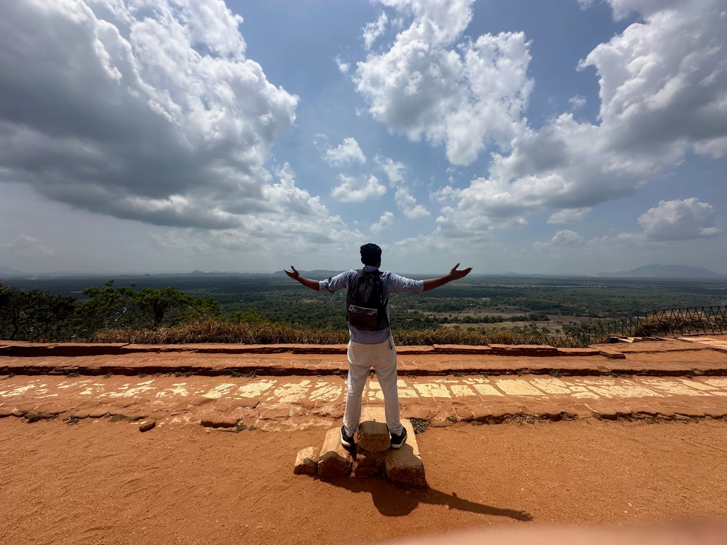 Arms out at the summit of Sigiriya rock fortress, Sri Lanka